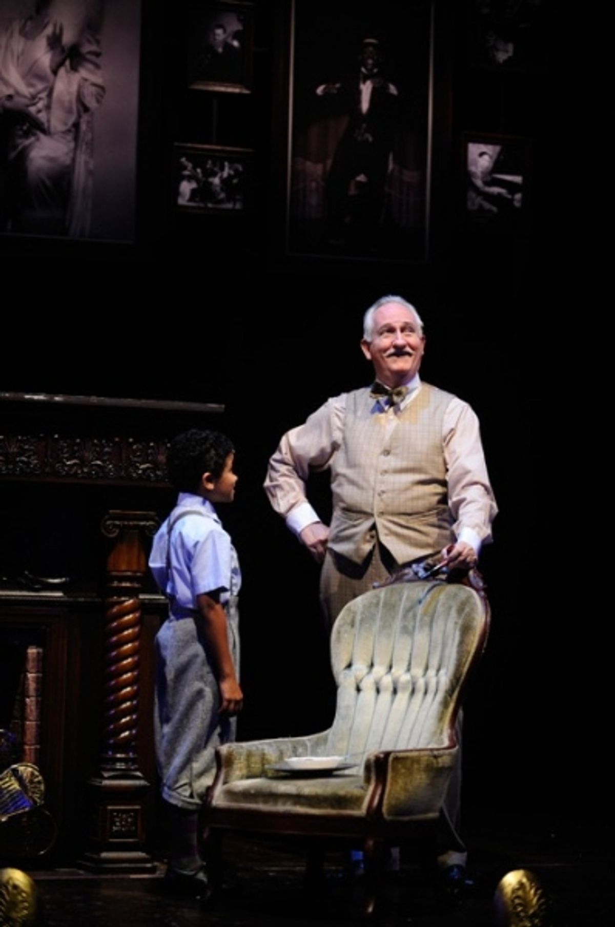 Twist (left, Alaman Diadhiou) speaks with Mr. Prudhomme (E. Wade Benson) at 